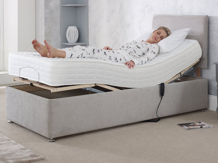 A woman lies comfortably on an adjustable bed, embracing a restful sleep on a cozy mattress.