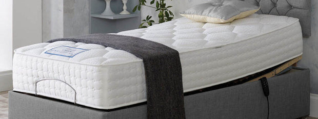 A cozy adjustable bed mattress topped with a fluffy pillow, ready for a restful night's sleep.