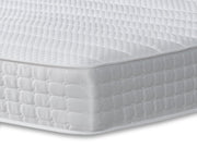 A simple white mattress with a smooth cover, placed on a white base, perfect for a serene bedroom aesthetic.