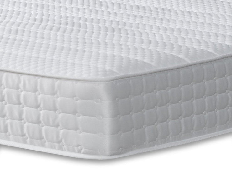 A simple white mattress with a smooth cover, placed on a white base, perfect for a serene bedroom aesthetic.