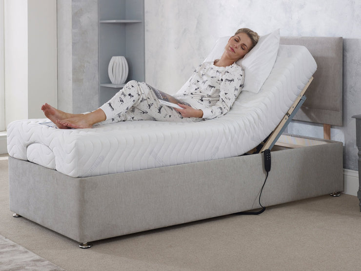 A woman resting on an grey adjustable bed, enjoying a nap