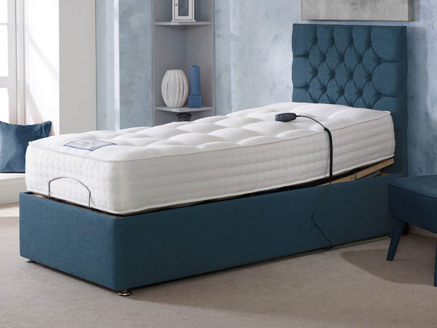  A blue adjustable bed featuring a comfortable mattress and a stylish blue headboard.